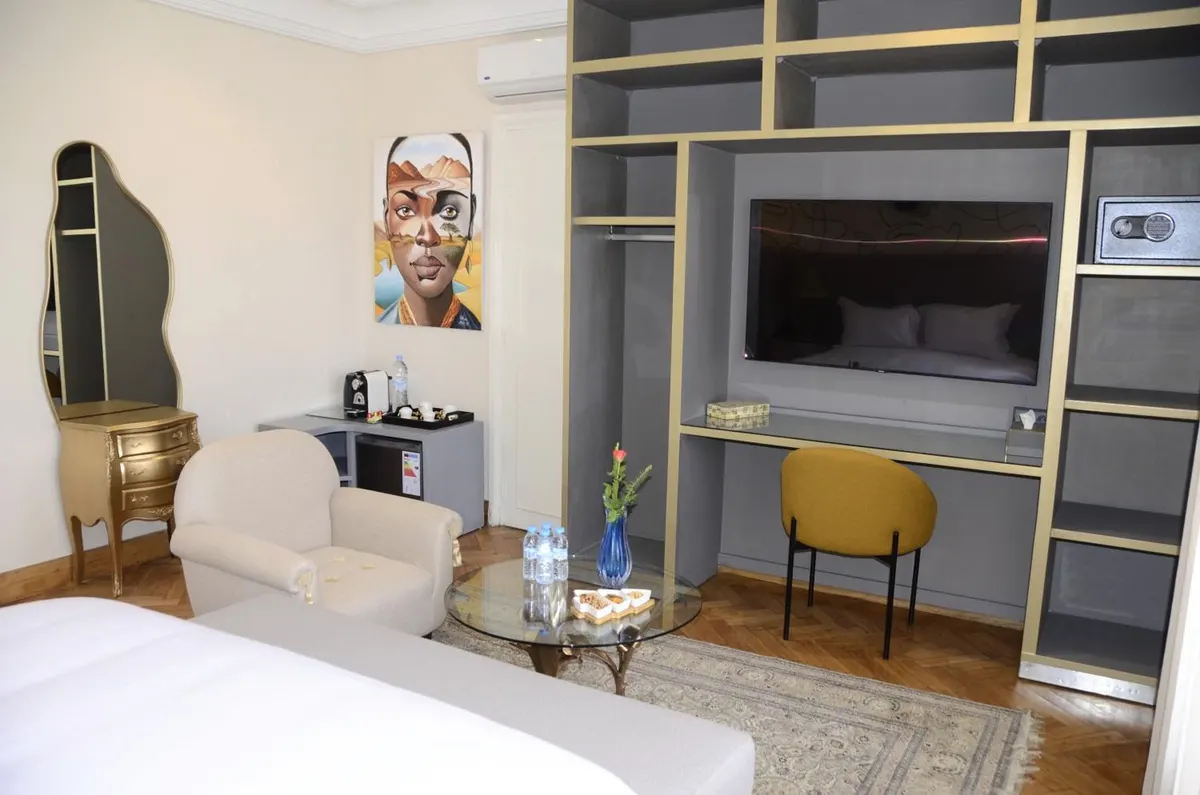 Deluxe Double Room: pop-art portrait above the sitting corner.
