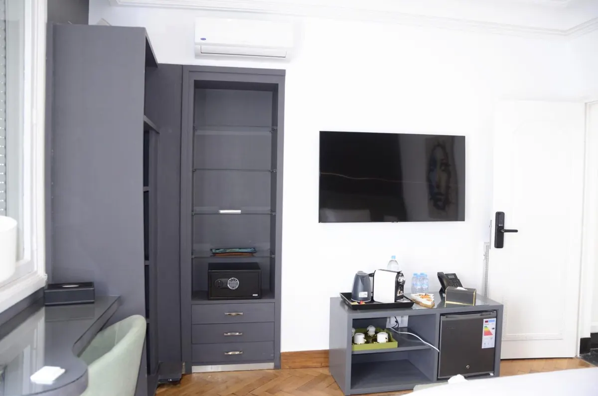 Double Room: wardrobe, television and a desk with the coffee machine and fridge.